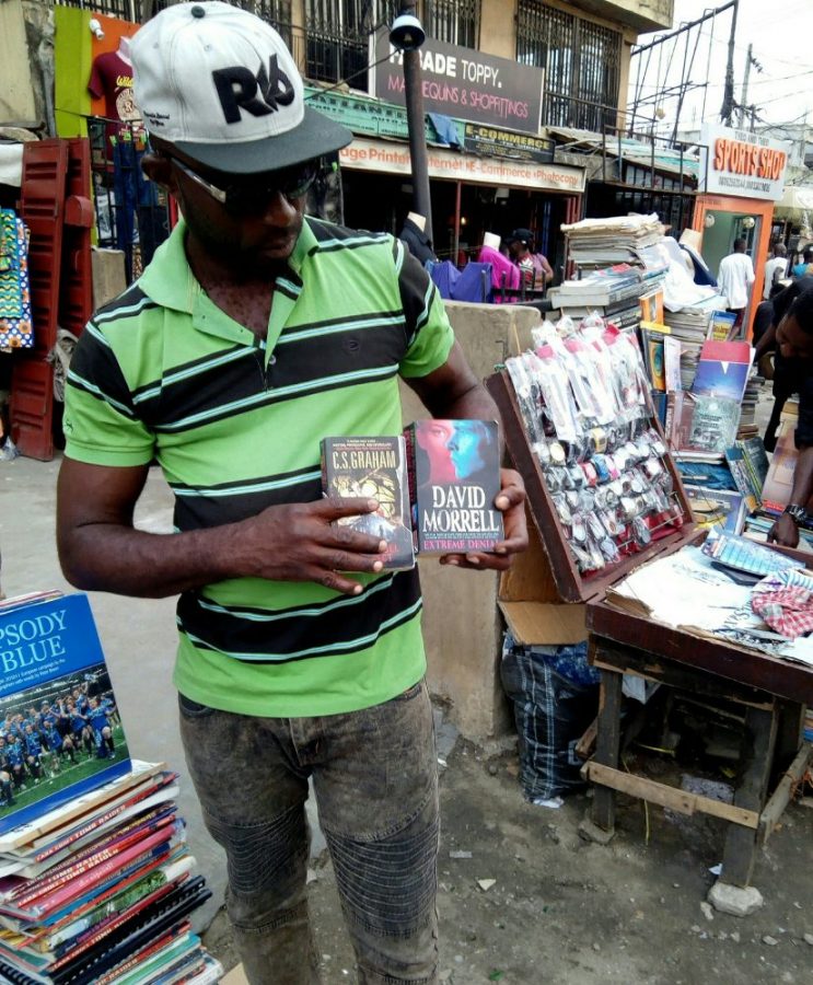 Alex holding two of the books we eventually bought.